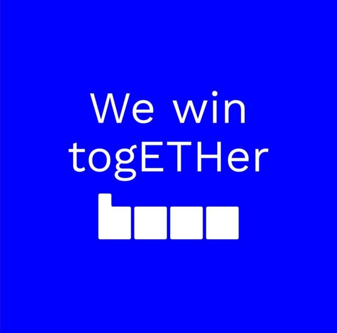 The image features a blue background with white text that reads "We win together". The text is centered above a picture of four buttons, each button displaying the number 1. This arrangement creates an interesting visual effect where the numbers are directly below the words in the center. The overall design and layout of the image suggest it could be related to a social media post or advertisement promoting unity and collaboration among users.
