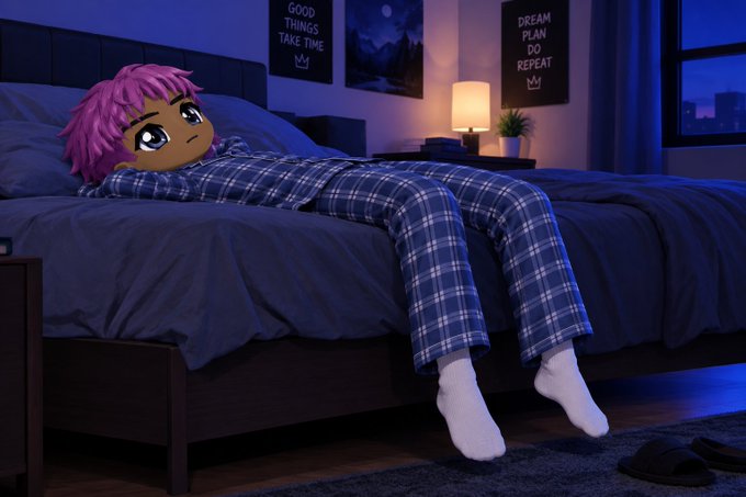 A pink-haired anime-style character lies on a bed in a dimly lit blue bedroom, wearing blue and white plaid pajamas, with wall art reading 'GOOD THINGS TAKE TIME' and 'DREAM PLAN DO REPEAT' visible in the background.