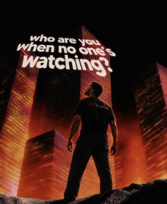 A man wearing a 'BTC Venom' t-shirt stands looking up at towering, illuminated skyscrapers against a starry night sky, with text overlay reading 'who are you when no one's watching?'