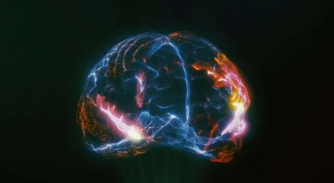A digital illustration depicts a translucent, glowing human brain rendered with blue, orange, and pink light particles against a dark background.