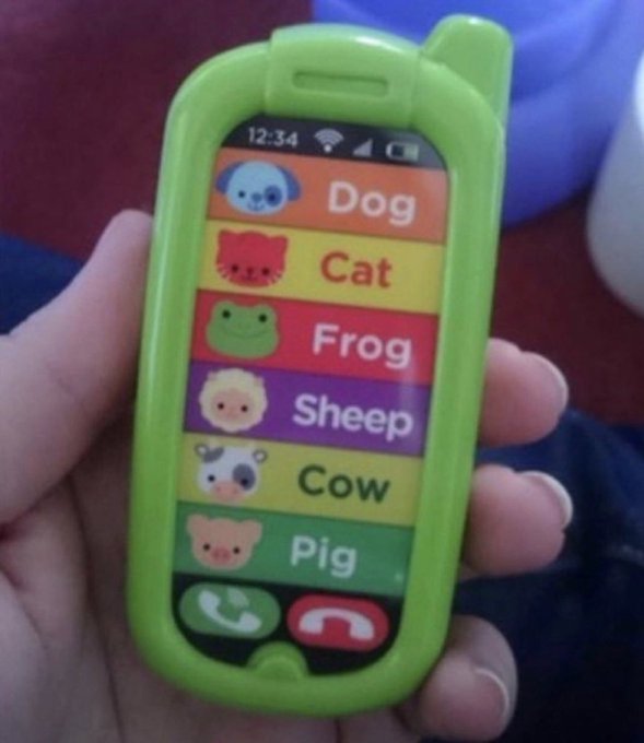 A hand holds a green toy smartphone displaying an animal sound app with colorful buttons for Dog, Cat, Frog, Sheep, Cow, and Pig. The post humorously compares the simplicity of the toy phone to their memecoin portfolio, implying it's as basic and unserious as a children's toy.