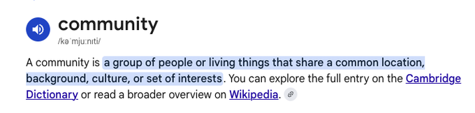 A dictionary definition of "community" reading: "A community is a group of people or living things that share a common location, background, culture, or set of interests," with links to Cambridge Dictionary and Wikipedia.