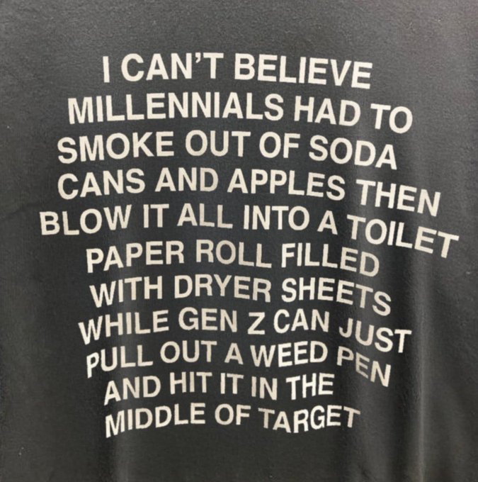 A black t-shirt with white text joking about millennials having to improvise smoking devices from soda cans, apples, toilet paper rolls, and dryer sheets while Gen Z simply uses weed pens.
