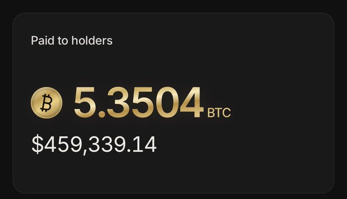 A dark screen displaying 'Paid to holders' with 5.3504 BTC (Bitcoin logo) and the USD equivalent of $459,339.14.
