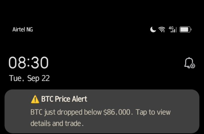 Mobile phone lock screen from Airtel NG displaying the time 08:30 on Tuesday, September 22, with a BTC Price Alert notification that reads 'BTC just dropped below $86,000. Tap to view details and trade.'