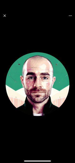 The image features a man's face, which appears to be bald or shaved, as he looks directly into the camera with an expression of surprise. The background of the image is black, making the man stand out prominently. There are two other people in the image who seem to be involved in creating this post. One person is located at the top left corner and another one is situated at the bottom right corner. They appear to be discussing or working on a project related to the post. The text "$ATOM Another pig will feed from the shitty trough And spin tales about Cosmos's great future." seems to be part of their conversation, possibly referring to an ongoing project or collaboration involving the man's image and the post they are creating.