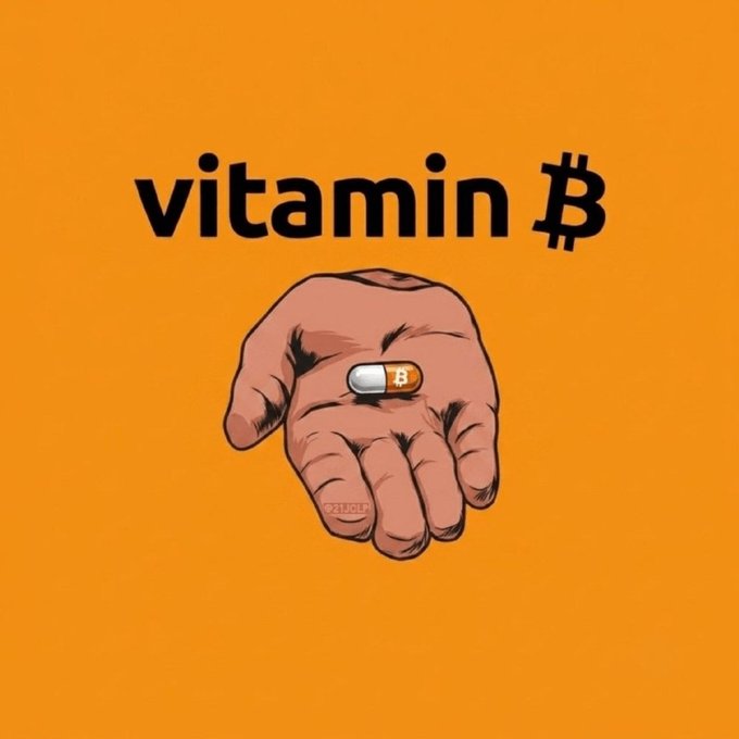 A graphic on an orange background shows a hand holding a capsule pill marked with the Bitcoin "₿" symbol, beneath the bold black text "vitamin ₿."