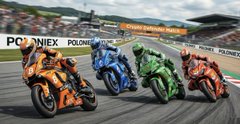 The image shows a group of four motorcyclists racing around a track, with one rider wearing an orange helmet and another wearing a green helmet. They are all riding motorcycles painted in different colors - blue, green, red, and orange. The riders appear to be competing against each other as they navigate the challenging course.