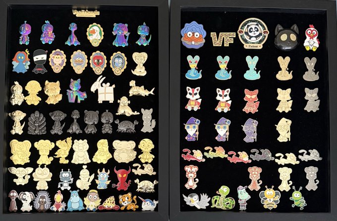 Two framed displays containing large collections of colorful enamel pins featuring various cartoon characters and designs.