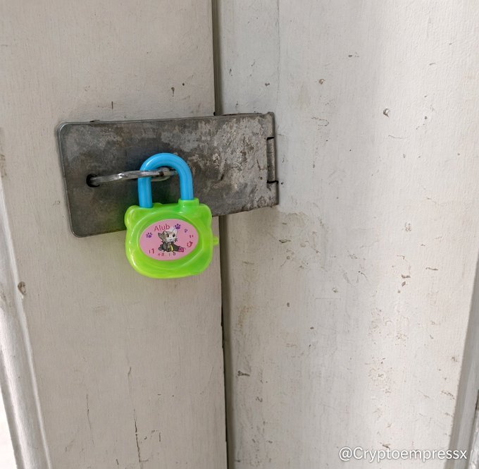 A rusted metal latch secures a wooden door with a bright green and blue "Club Pets" toy padlock—hardly the institutional-grade security one might hope for. The image humorously underscores the post's point by contrasting the childlike lock with the serious claim that "Bitget: user funds are safe" and "Bitget security," implying that crypto exchange security may be less robust than it claims.