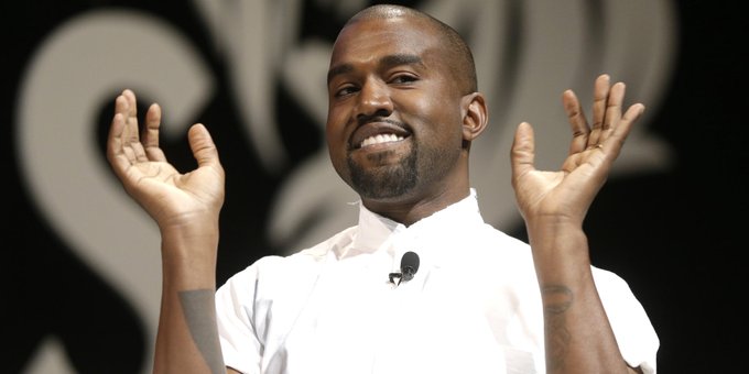 The image features a man with his hands raised, possibly in prayer or celebration. He appears to be wearing a white shirt and has tattoos visible on his arms. The background of the image is black, which contrasts with the white shirt and makes the tattooed areas stand out more prominently. The text "read the vitalik novel intro" suggests that this man might be involved in promoting a novel or an event related to it.