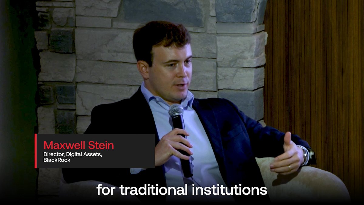 Maxwell Stein, Director of Digital Assets at BlackRock, speaks into a microphone at the Avalanche Summit, gesturing as he discusses blockchain solutions for traditional institutions to enable 24/7, 365-day-a-year markets, as indicated by the on-screen text "for traditional institutions."
