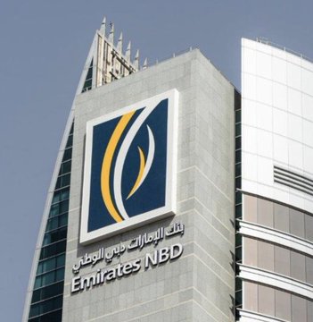 The image features a large, modern building with a prominent blue and yellow logo that reads "Emirates NDB" at its peak. The building also displays the text "It will allow 10 million customers to buy Bitcoin and crypto one of the largest banks in the Middle East". This suggests that the bank is actively promoting and supporting cryptocurrency adoption among its customers, potentially offering them a way to invest or purchase digital assets using their banking services.

The image captures an interesting moment where the bank's logo and message are prominently displayed on the building, drawing attention to the bank's involvement in the crypto market. The presence of such a large logo indicates that the bank is making efforts to stay ahead of its competitors and adapt to the rapidly changing financial landscape by offering innovative services like cryptocurrency trading.

The image also includes text about Bitcoin and crypto, which further emphasizes the bank's focus on digital assets and their integration into the banking ecosystem. This could be a strategic move for the bank to attract tech-savvy customers who are interested in exploring new ways of managing their finances or investing in emerging markets.