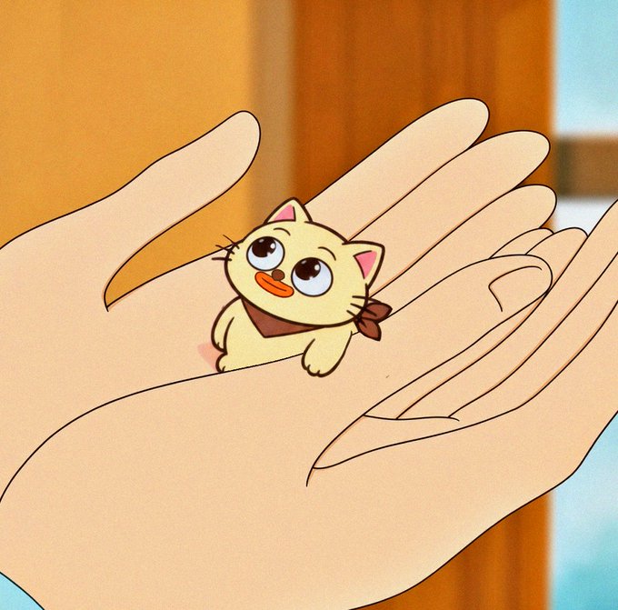 An animated illustration of a small yellow cartoon cat with large eyes and a brown bandana sitting in the palm of a person's hand.