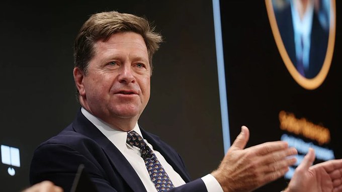 Jay Clayton, the former SEC Chairman who led the lawsuit against Ripple, is shown gesturing while speaking at a forum; he has been appointed to lead Trump's new "Super Intelligence Force" with 120 days to report, representing the same officials who once pressured XRP now shaping both crypto and AI policy.