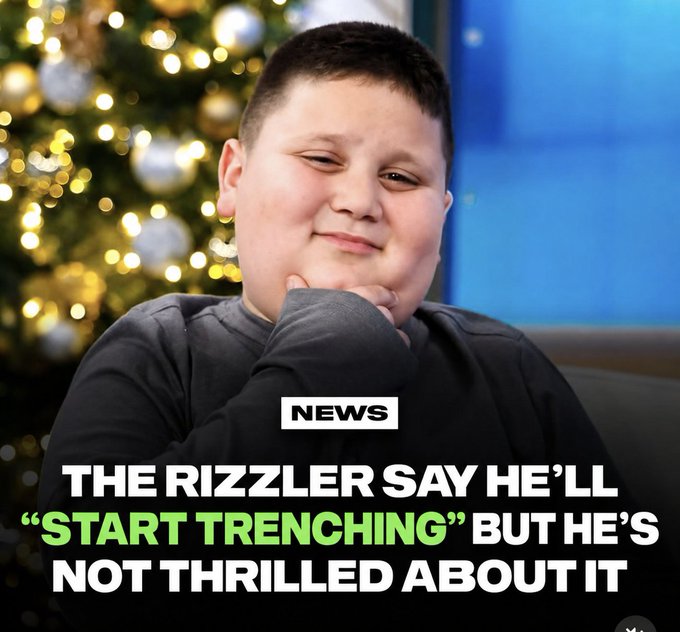 A young boy in a dark sweatshirt poses thoughtfully with his hand on his chin in front of a decorated Christmas tree, with a news headline overlay reading "THE RIZZLER SAY HE'LL 'START TRENCHING' BUT HE'S NOT THRILLED ABOUT IT."