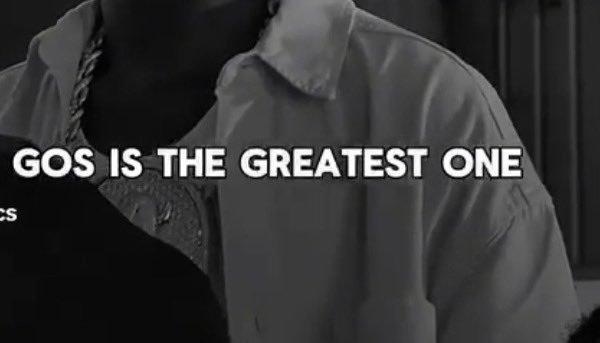 A black-and-white image of a person wearing a chain necklace and white shirt, with bold white text reading "GOS IS THE GREATEST ONE".