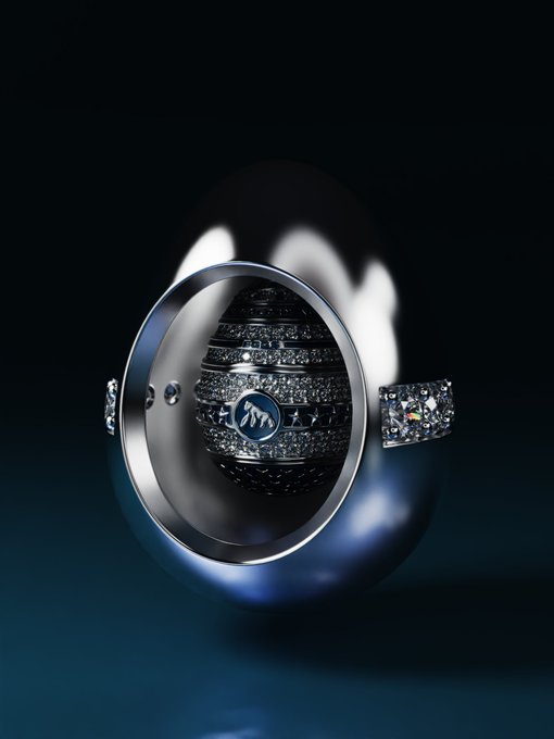A close-up product image displays a luxurious silver ring with intricate engraved details and a central logo emblem.
