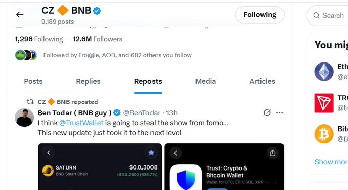The image shows CZ's Twitter profile where he has reposted Ben Todar's tweet promoting Trust Wallet, featuring a screenshot of a BNB Smart Chain wallet showing "SATURN" with a $0.3,3008 price (+$0.26,060 or 8,367%), supporting the post's claim about CZ amplifying Saturn's visibility through Trust Wallet integration.