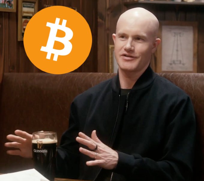 A bald man wearing a black jacket sits at a table with a glass of Guinness beer, with a large orange Bitcoin logo overlaid on the image.
