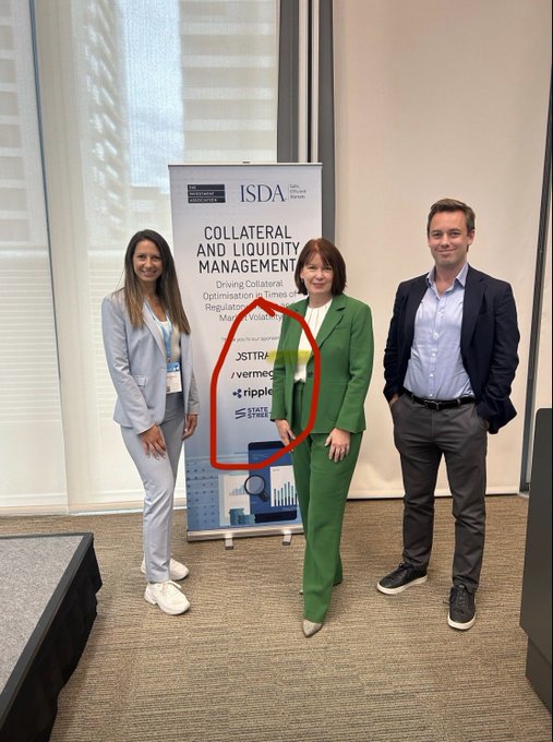 Three professionally dressed individuals pose in front of an ISDA "Collateral and Liquidity Management" event banner featuring sponsors Osttra, Vermeg, Ripple, and State Street, representing key partners in the U.S. TMMF Sandbox initiative. The image visually reinforces the post's emphasis on major industry collaboration between ISDA, Ripple, Osttra, Bank of England, and CME in advancing collateral tokenization and RWA initiatives.