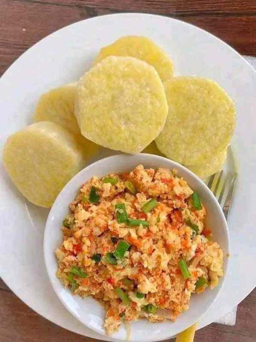 A plate of golden fried cassava slices served alongside a bowl of scrambled tofu mixed with carrots and green onions.
