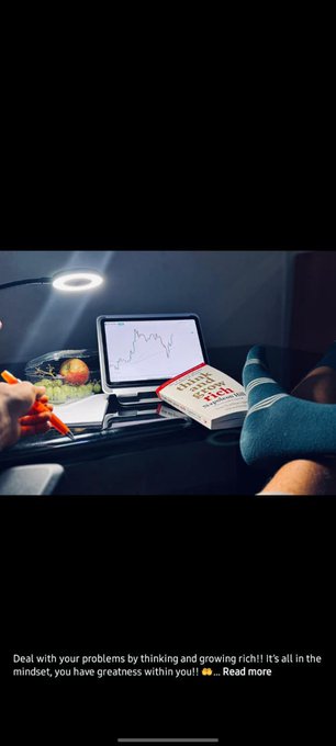 A dimly lit scene of a person studying at a desk with a lamp, a laptop showing a stock chart, a book titled 'Think and Grow Rich,' and a bowl of fruit, with a caption about dealing with problems by thinking and growing rich.