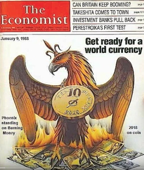 The cover of a magazine features an illustration of a phoenix, which is a mythical bird often associated with fire and destruction. In front of the phoenix are two piles of money, symbolizing wealth or currency. The phrase "Get Ready For A World Currency" is written above the phoenix, suggesting that there might be a connection between the phoenix's fiery nature and the concept of a world currency.