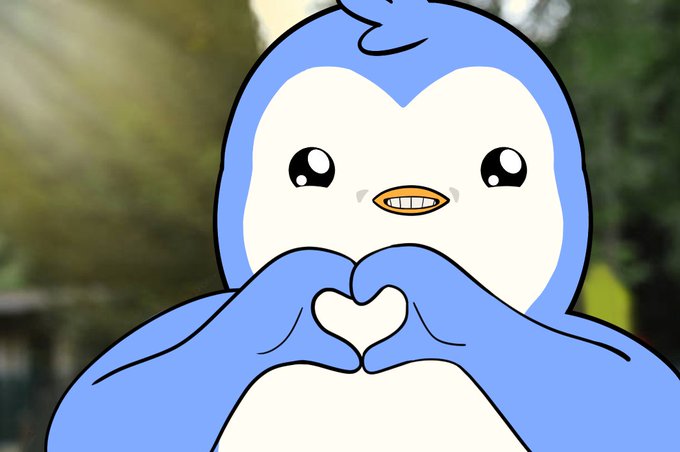 A cartoon penguin with a blue body and white belly making a heart shape with its hands, set against a blurred outdoor background.