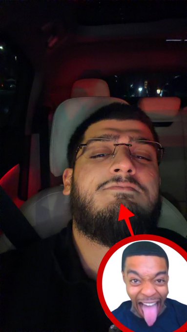 A selfie of a man with glasses sitting in a car at night, with a red arrow pointing to his beard and an inset circular image of a person with their tongue sticking out.