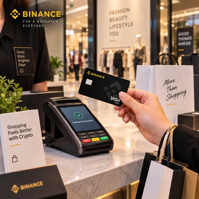 A customer's hand holds a black Binance Visa debit card over a payment terminal displaying "Payment Successful" at a retail checkout, with signage reading "Binance — For a Brighter Everyday," "Fashion Beauty Lifestyle You," "Good Things Ahead," and "Shopping Feels Better with Crypto," visually illustrating how the Binance Card is used in everyday transactions.