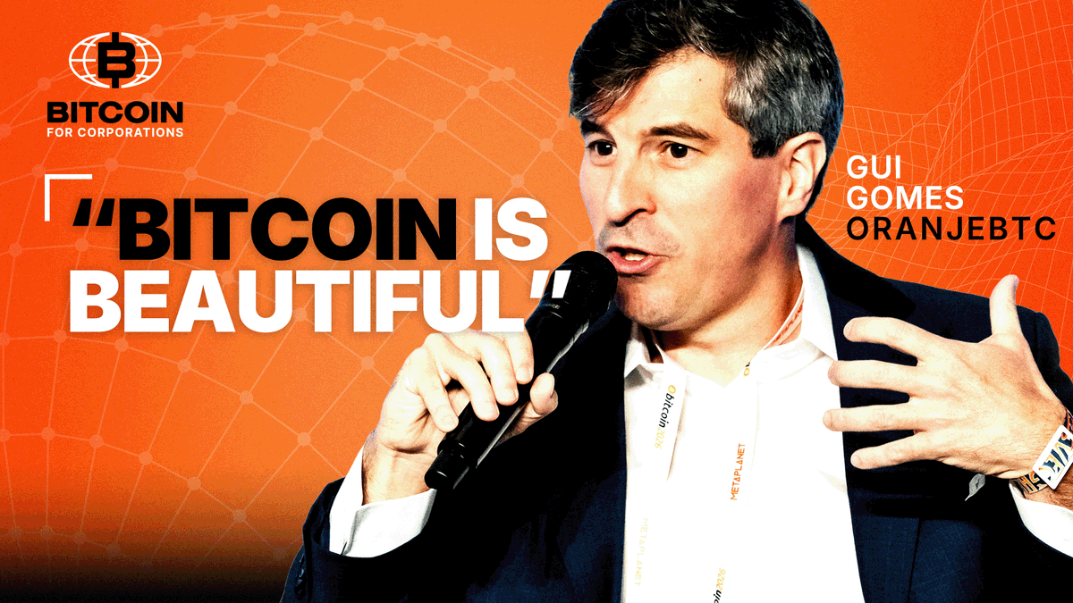 The image features a man wearing a suit standing next to a microphone, giving him a commanding presence as he speaks into it. The background of the image is orange with white text that reads "Bitcoin is beautiful!". This suggests that the man speaking might be promoting Bitcoin or discussing its beauty in some way.