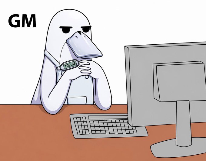 A cartoon illustration of a hooded figure with a beak-like mask sitting at a desk in front of a computer monitor, with the text 'GM' (good morning) in the upper left corner, a common crypto/Web3 greeting meme.