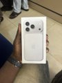A close-up of a boxed iPhone 17 Pro Max being passed between two people, visually illustrating the punchline of the post about a crypto "degen" who distributed all ETH proceeds from his project "Garri" to buy a 2TB iPhone 17 Pro Max instead of supporting his token holders.