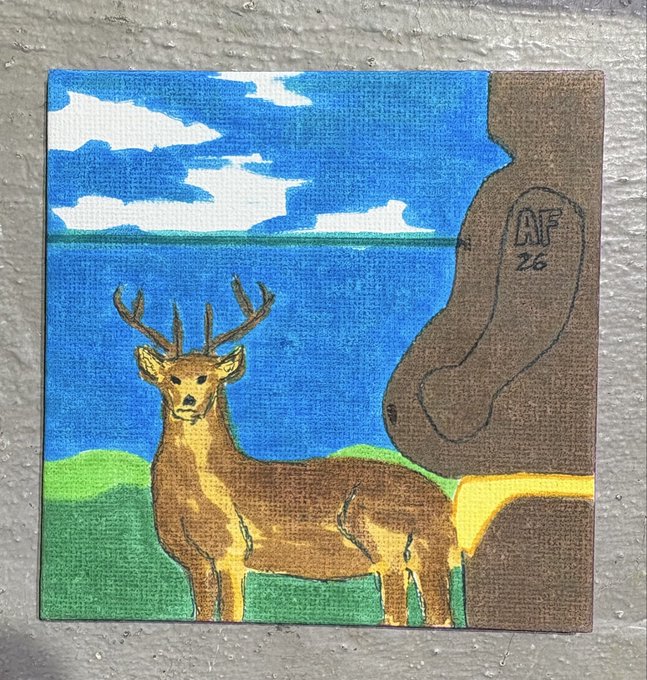 A small canvas painting depicting a deer standing on a grassy shore with a blue sea and cloudy sky, signed 'AF 26' on the brown rock formation.
