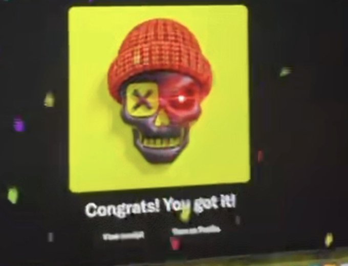 A screen displaying a 3D skull character wearing a red beanie with an X on one eye and a glowing red other eye, with text reading 'Congrats! You got it!'