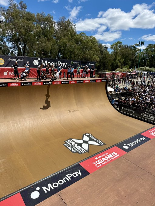 A skateboarder drops into a large halfpipe ramp at the X Games 2026 in Sacramento, surrounded by "MoonPay" and "Google Cloud" branding, while spectators watch from the sidelines.
