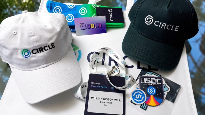 Promotional items like caps, socks, and badges featuring the "CIRCLE" logo, along with a "Circle in Buenos Aires" lanyard for "WILLIAN RISSON WILL" of Smartvault, are displayed, signifying an event in Buenos Aires related to the Circle ecosystem and USDC.