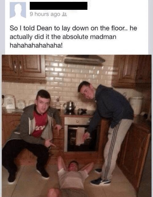A social media post captioned 'So I told Dean to lay down on the floor.. he actually did it the absolute madman hahahahahahaha!' showing three men in a kitchen with one lying on the floor.
