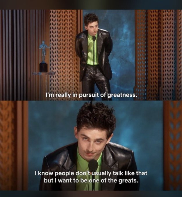 Two screenshots of a man in a black leather jacket giving an acceptance speech, with subtitles reading 'I'm really in pursuit of greatness' and 'I know people don't usually talk like that but I want to be one of the greats.'