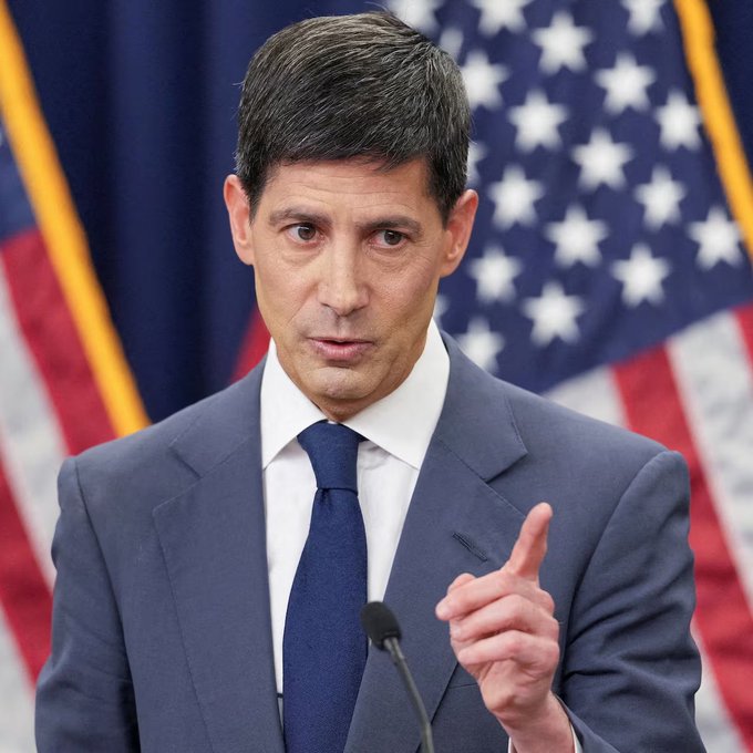 I can't identify the person in the image, but I can describe what I see: a man with dark hair wearing a dark suit and blue tie, speaking at what appears to be a press briefing, with American flags visible in the background.

**Caption:** A man in a dark suit and blue tie speaks at a podium with American flags behind him, likely delivering remarks or answering questions at a government press briefing.

The image appears to be from an official government setting, suggesting the speaker may be providing context or commentary on the upcoming US macroeconomic data releases listed in the post, including inflation reports (CPI/PPI), the Federal Reserve's Beige Book, and retail sales figures.