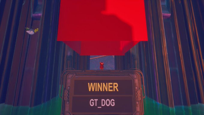 A video game screen displays a 'WINNER' sign reading 'GT_DOG' beneath a large red cube and a small red character.