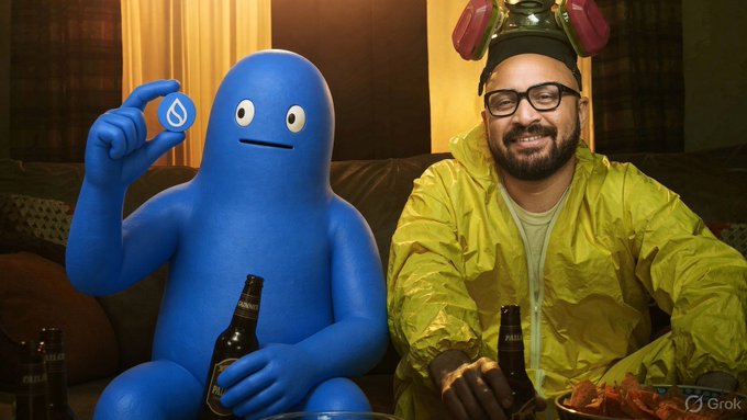 A man wearing a gas mask and yellow hazmat suit sits next to a blue cartoon blob mascot, both holding beer bottles, with the man holding a plate of chicken wings. The accompanying text references "$ONE $SUI," suggesting this is a promotional image for a crypto project featuring a playful cooking partnership between the mascot and the human host.