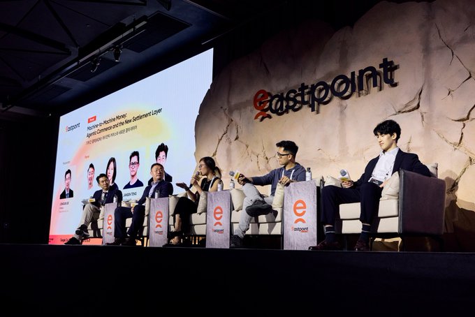 A panel discussion at EastPoint:Seoul 2026 features six speakers seated on stage in front of a large "eastpoint" sign, with a screen displaying the session title "You've Orchestrate Now Agentic Commerce and the New Settlement Layer." The image illustrates the event referenced in the post, where Kite participated in multiple panels exploring the agent economy, agentic commerce, and financial infrastructure.