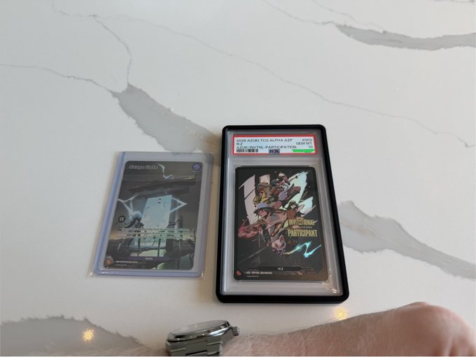 Two trading cards in protective sleeves displayed on a marble surface, including a holographic 'ARCEUS VSTAR' card and a graded 'UNSTOPPABLE PARTY CRASHER' card, with a person's thumb visible at the bottom.