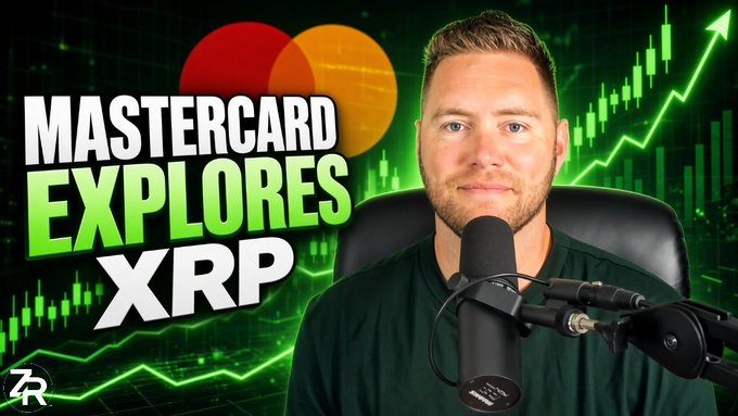 A YouTube thumbnail featuring a man speaking into a microphone with bold text reading "MASTERCARD EXPLORES XRP" alongside the Mastercard logo, set against a green rising stock chart background, illustrating the post about Mastercard joining the XRP family in New York.