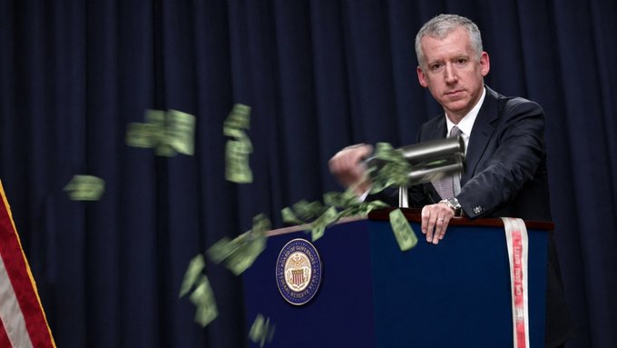 Federal Reserve official at a podium tossing dollar bills into the air with the Federal Reserve seal visible.
