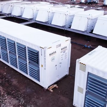 An outdoor industrial facility housing rows of large white MARA-branded shipping containers, likely used for cryptocurrency mining.