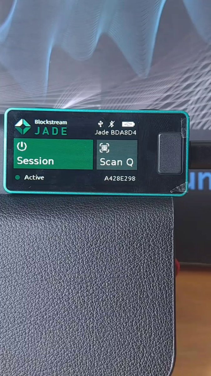 The image features an electronic device with a green screen that displays an interface for Shrincs, a software application developed by Blockstream. The Shrincs app provides a means to protect Bitcoin transactions from potential quantum attacks, ensuring the security of the cryptocurrency without needing to alter its core programming. This innovative technology has been recognized as potentially game-changing in the Bitcoin community and is being utilized to improve the overall security and resilience of the Bitcoin network.