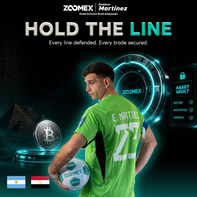 A promotional image featuring Argentine goalkeeper Emiliano "Dibu" Martínez as a Zoomex Global Exclusive Brand Ambassador, with the text "HOLD THE LINE – Every line defended. Every trade secured." and an "Asset Vault" panel showing Secure, Encrypted, and Verified statuses. The image ties into the Argentina vs. Egypt match giveaway by playing on Martínez's goalkeeper role—holding the line on the pitch mirrors Zoomex's promise of secure, verified crypto trading.